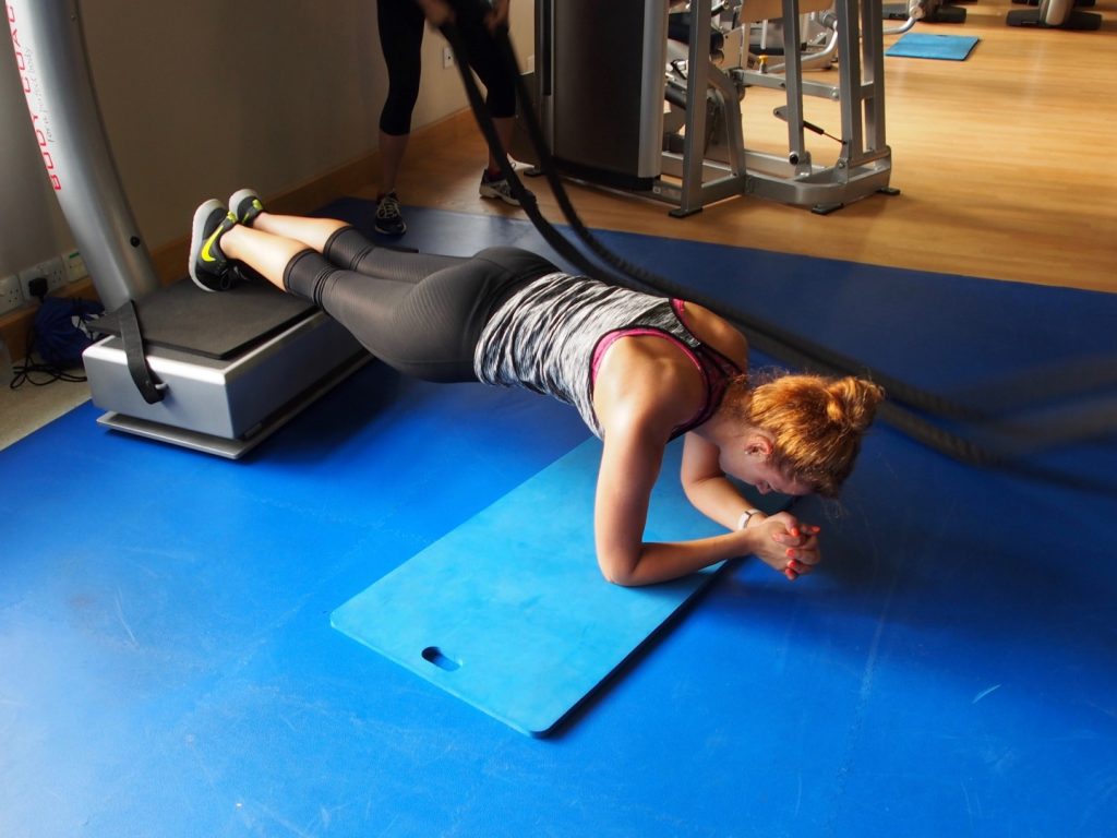 Underfoot, a machine that vibrates to add resistance to and crank up the difficulty of this plank exercise.